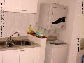 Kitchen with washer, dryer, garbage chute. Burlington Square Residence, Singapore