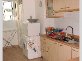 Bright kitchen but small maid's room.