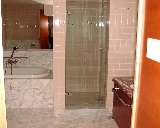 Squarish glossy tiled bathroom walls