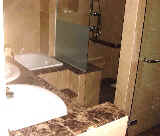 Frameless shower cubicle and modern master bathroom